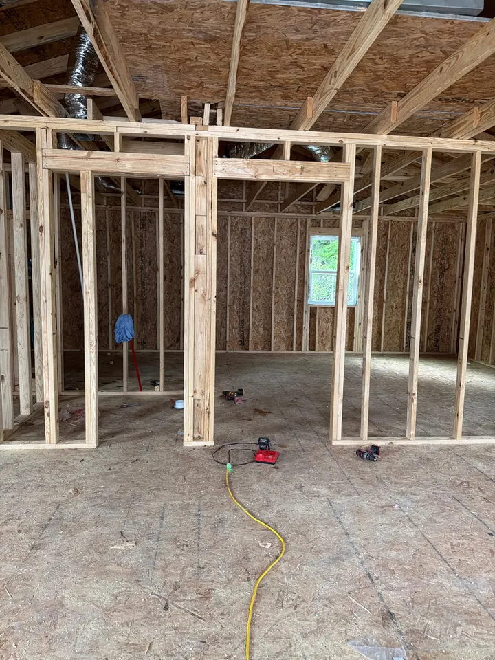 White PVC piping visible within the framing of an unfinished interior